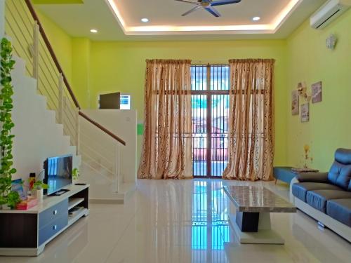 a living room with green walls and a ceiling at Sky Mirror Homestay in Kuala Selangor