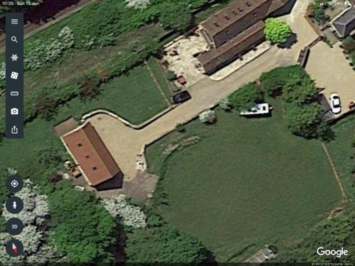 an overhead view of a park with a car in a field at Highcroft House in Corsham