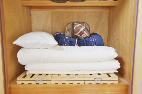 a stack of pillows sitting on a shelf at Villent Fujimi Hiekawa in Izu