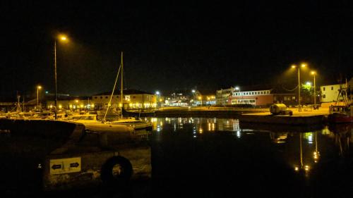 a marina at night with boats in the water at Harbour Sleep in Neksø