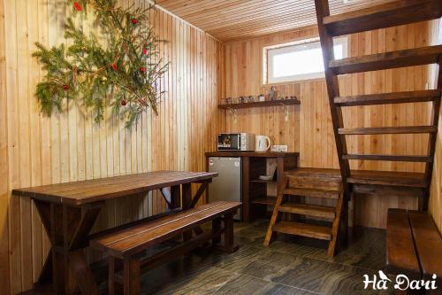 a small kitchen with a table and a stove at Комплекс На Дачі in Vyshpolʼ