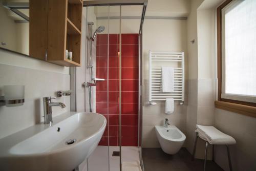 a bathroom with a sink and a shower and a toilet at Hotel Terme in Bormio