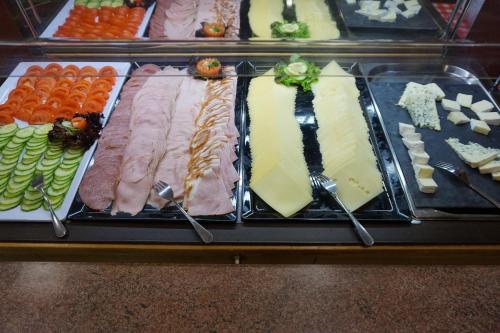 a display case with different types of meats and cheese at Hotel Untermetzger in Zell am Ziller