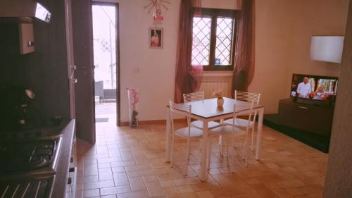 a kitchen with a table and chairs in a room at Villa Elegance in Ladispoli