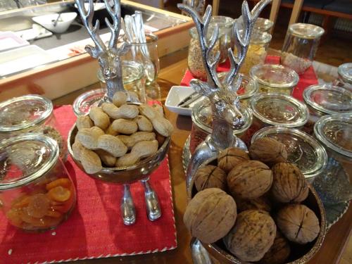 a table topped with bowls of nuts and plates of food at Parkhotel Sole Paradiso in San Candido