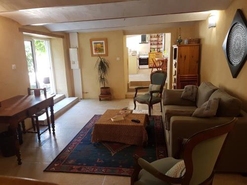 a living room with a couch and a table at Maison Atypique au pied du château in Montélimar