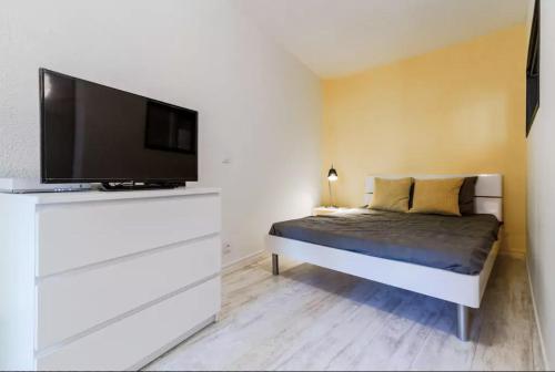 a bedroom with a bed and a flat screen tv at T2 Design Hypercentre Capitole in Toulouse