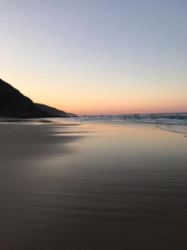 a view of the beach at sunset at Dolphin's Nook in Groot Brak Rivier