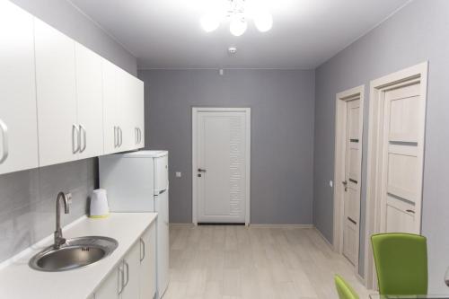 a kitchen with a sink and a refrigerator at Apartments near Dolphinarium in Truskavets