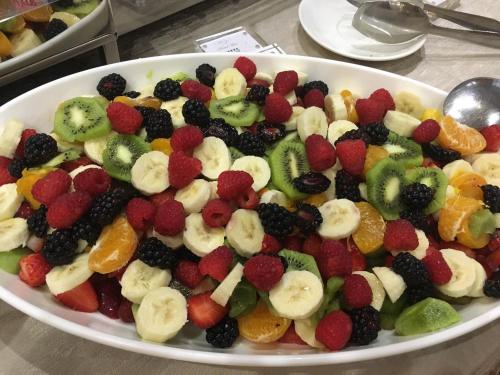 a plate of fruit salad on a table at Hotel Teco in Milan