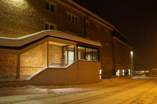 a building at night with snow on the ground at Alpine Lodge Klösterle am Arlberg in Klösterle am Arlberg