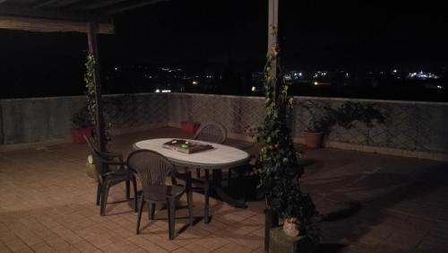 a table and chairs on a patio at night at Attico a Barberino di Mugello in Barberino di Mugello