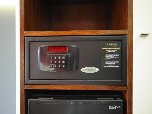 a microwave oven sitting inside of a wooden cabinet at Caramell in Louny