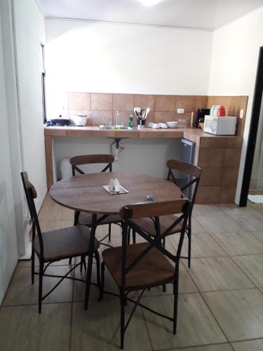a kitchen with a wooden table and chairs in a room at Vida Aventura Ranch in Tanques