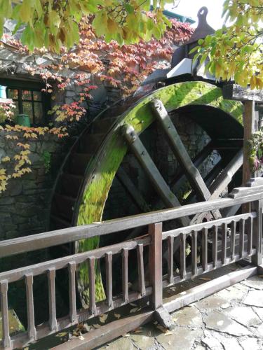 a stone bridge with a waterway in a park at Pension Brusenka in Bystřice pod Hostýnem