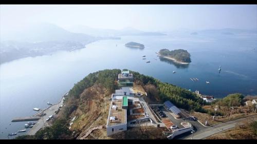 an aerial view of a building on an island in the water at Geoje Seaside Luxury Family Villa in Geoje 