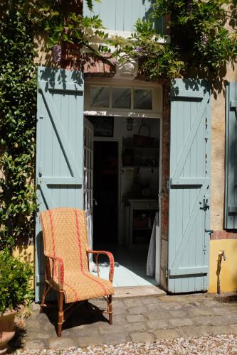 an open garage door with a chair in it at Le clos du Ru in Presnoy