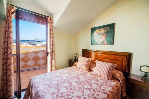 a bedroom with a bed and a large window at LA ATALAYA GREAT LUXURY ATTIC in Antequera