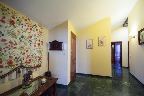 a hallway with a flower mural on the wall at LA ATALAYA GREAT LUXURY ATTIC in Antequera