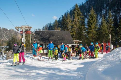 a group of people on skis in the snow near a ski lift at Burnout Wildalps in Wildalpen