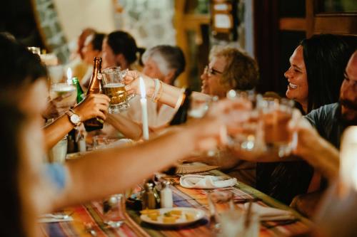 a group of people sitting at a table drinking beer at Hotel La Casa del Mundo in Jaibalito