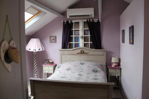 a bedroom with a bed and two night stands at Le Ch'tipanier in Morcenx