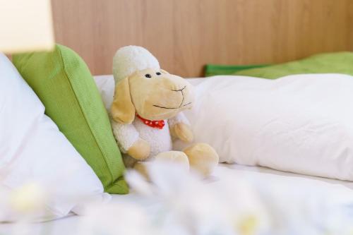 a stuffed animal is sitting on a bed at INhouse - Wohnen auf Zeit in Ingolstadt
