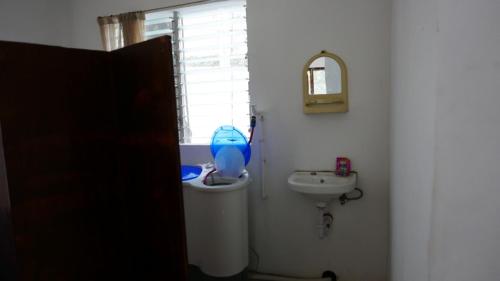 a bathroom with a toilet and a sink at JSB Residences Cebu A-flat in Tugbongan