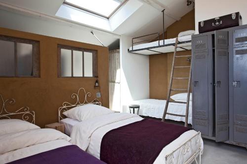 a bedroom with two beds and a bunk bed at Le392Bis in Échiré
