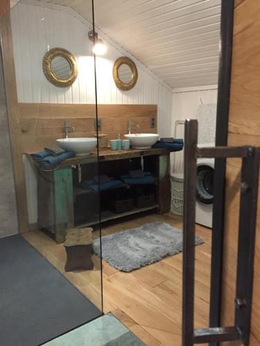 a bathroom with two sinks and two mirrors at La Fermette du Lac in Spa