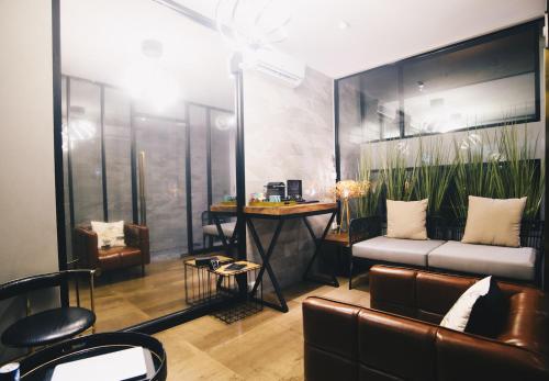 a living room with a couch and a table at Searocco Phuket in Patong Beach