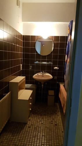 a small bathroom with a sink and a mirror at Isola Bella in Blankenberge