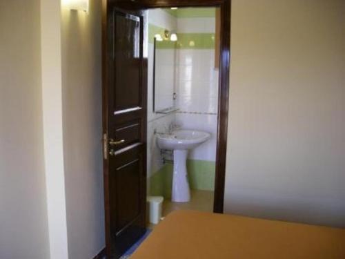 a bathroom with a sink and a toilet and a mirror at Casa Nel Corso in Castellammare del Golfo