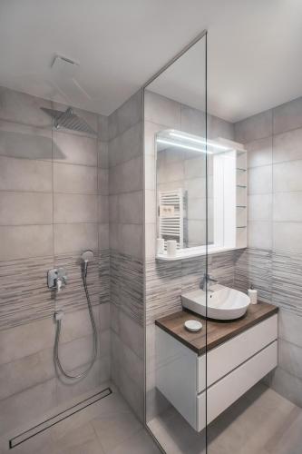 a bathroom with a sink and a shower at APARTMA KATKA Vila Mojca in Kranjska Gora