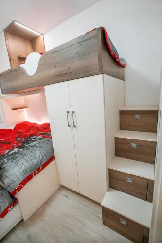 a small bedroom with a bunk bed and a closet at APARTMA KATKA Vila Mojca in Kranjska Gora