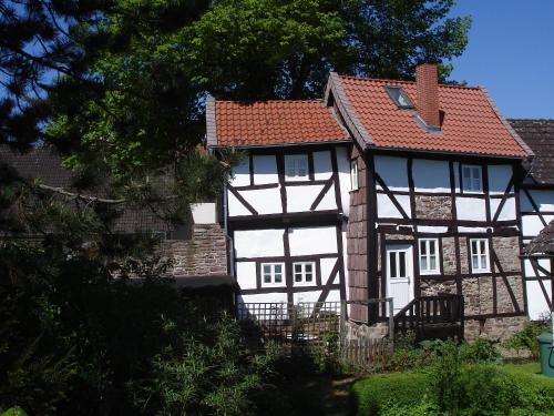 ein weißes und schwarzes Haus mit rotem Dach in der Unterkunft Ferienhaus am Solling in Dassel