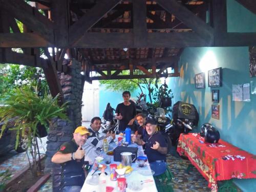 a group of people sitting at a table at Pousada 4 cantos in Corumbá