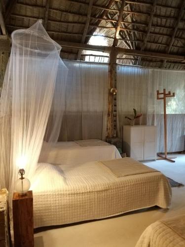 a bedroom with two beds and a cross in it at El Valle Lodge in El Valle