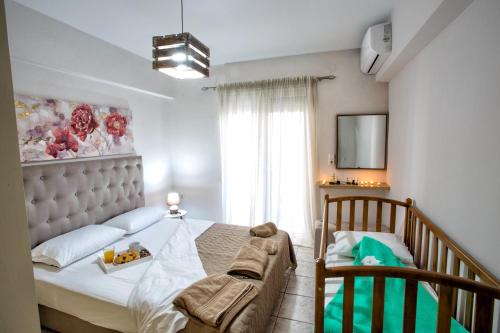 a bedroom with a large bed and a window at Holiday House Ioanna in Nea Peramos
