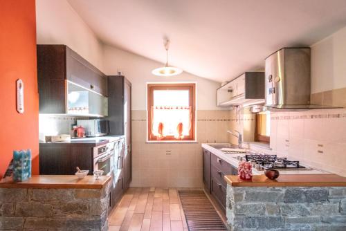 a kitchen with a sink and a stove top oven at Casa di Tia in Aosta