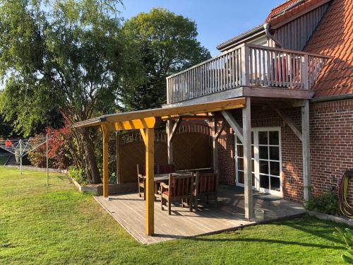 a deck with a balcony on top of a house at Die 5 Ferienwohnungen der Familie Weber in Fehmarn