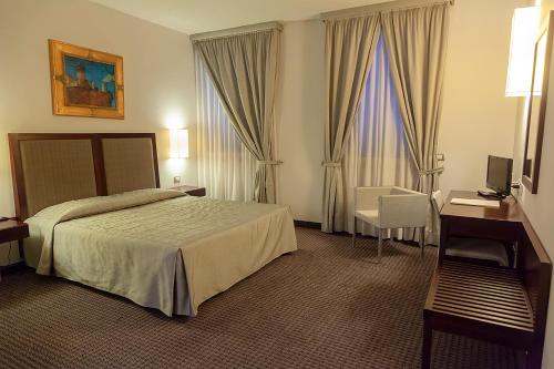Ένα ή περισσότερα κρεβάτια σε δωμάτιο στο Hotel dei Gonzaga