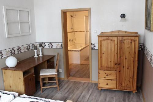 a bathroom with a wooden desk and a bath tub at Ferienwohnung Schwarz in Benshausen