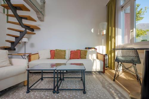 a living room with a couch and a table at Romantic Bijou in Lugano