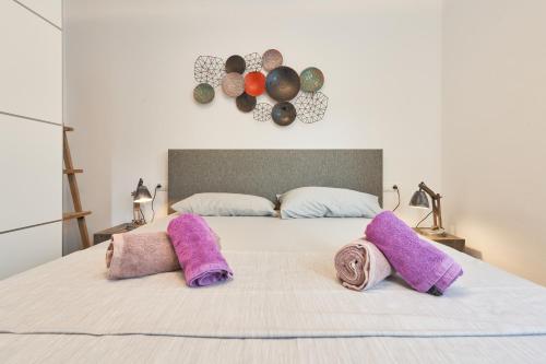 a bedroom with a bed with two pillows on it at Casa Bianca in Cala Vadella