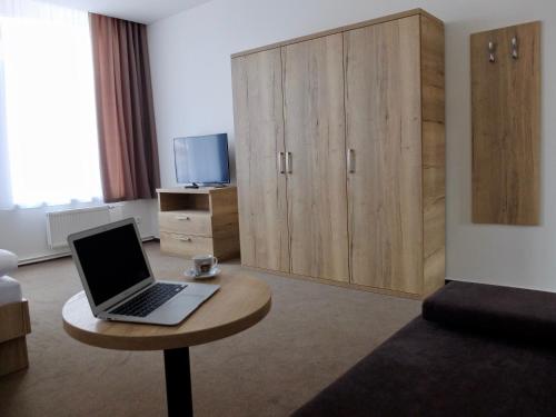 a laptop computer sitting on a table in a room at Penzion Stará pošta in Frýdek-Místek