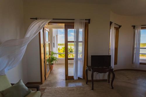 a living room with a door open to a balcony at Brahma Blue Resort in San Pedro