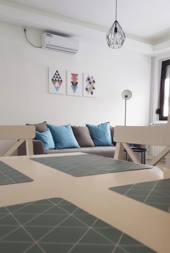 a living room with a couch and a table at Apartments Spring in Čačak