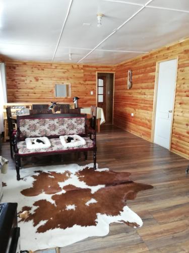 a room with a bed and a rug on the floor at Puesto Cánogas in Villa O'Higgins