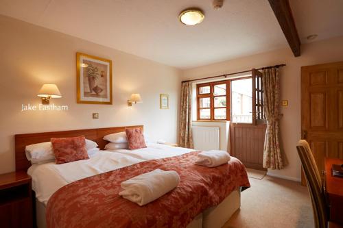 a hotel room with two beds and a window at Sid Valley Country House Hotel in Sidmouth